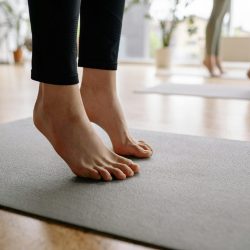 Close-up of bare feet during a yoga session indoors, focusing on mindfulness.